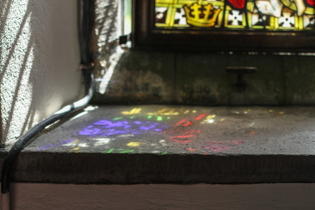 Beautiful colourful light patterns from the sun shining through the stained glass window